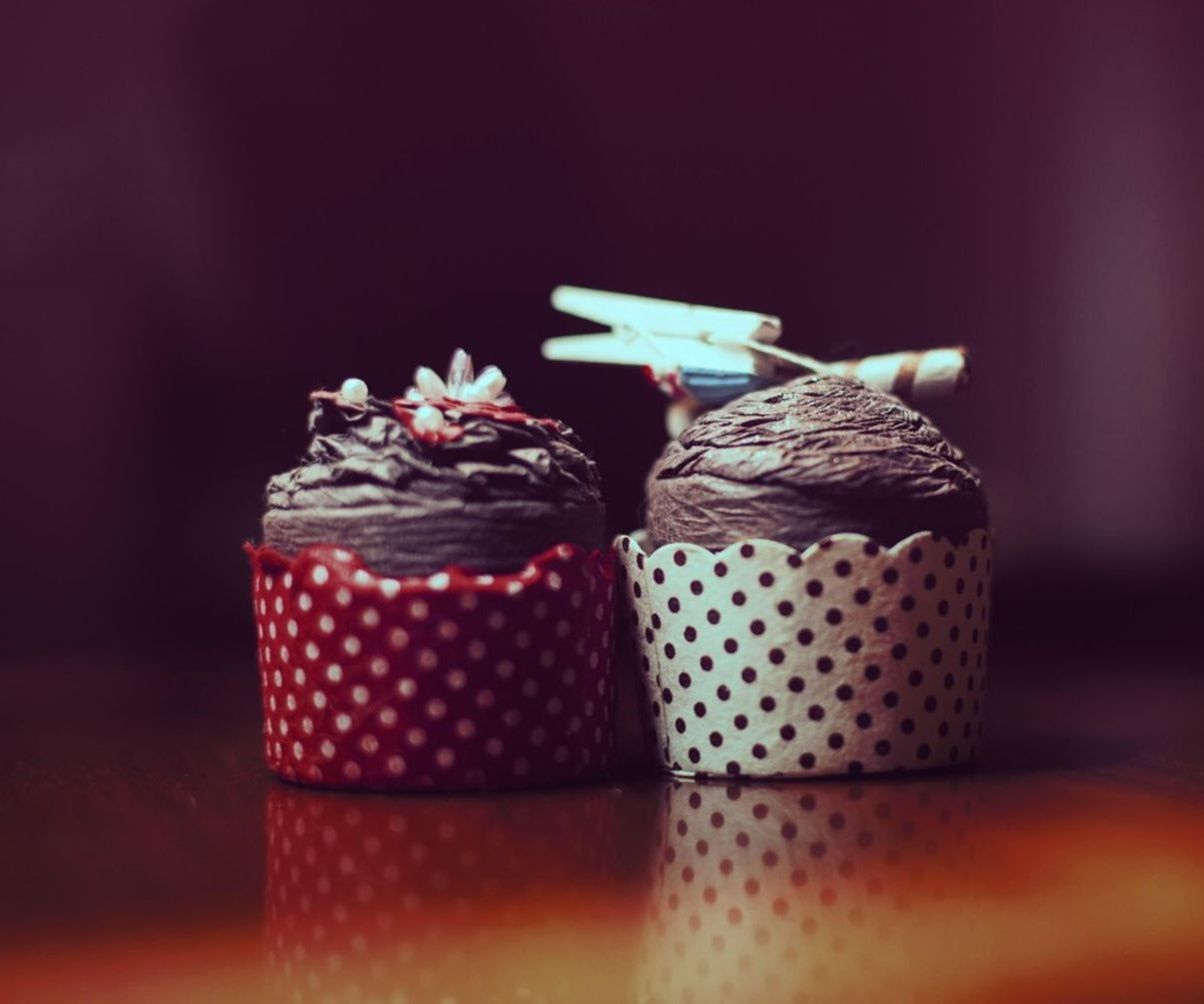 Artisan hand-dipping lollipops in rich chocolate coating